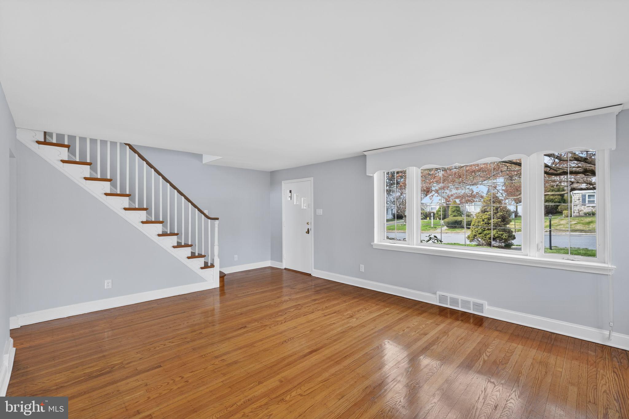 517 Weymouth Road Springfield, PA 19064 - Photo 5 of 31 a view of an empty room with wooden floor and a window