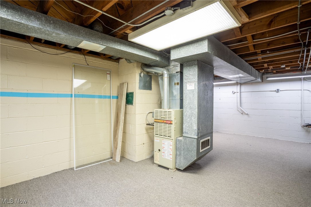 7654 Ragall Parkway Cleveland, OH 44130 - Photo 27 of 33 Unfinished below grade area with heating unit and carpet