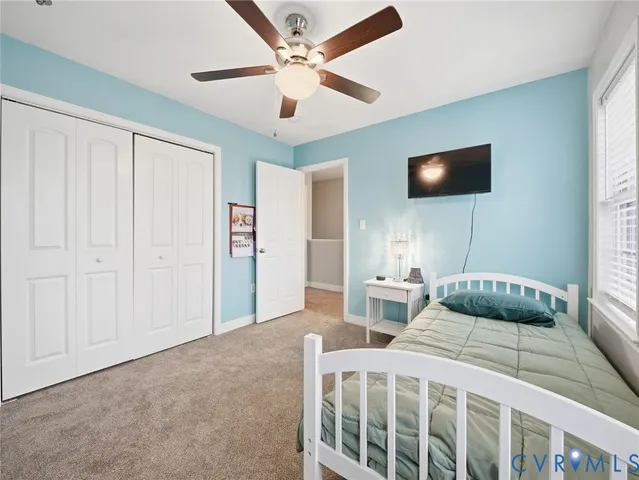 a bedroom with a bed and a tv