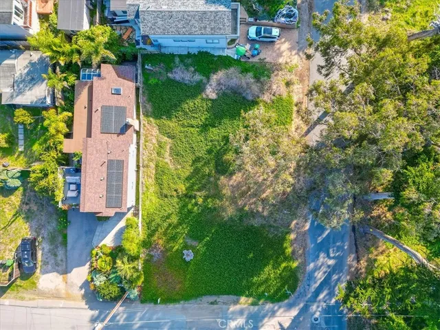 an aerial view of a house with a yard basket ball court and outdoor seating