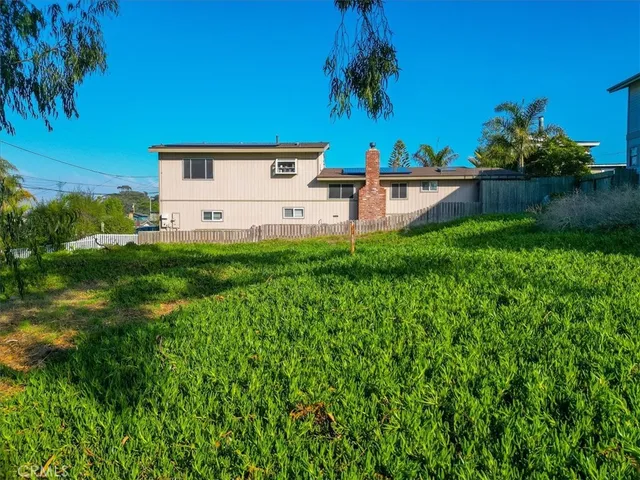 a view of backyard with plants and outdoor seating