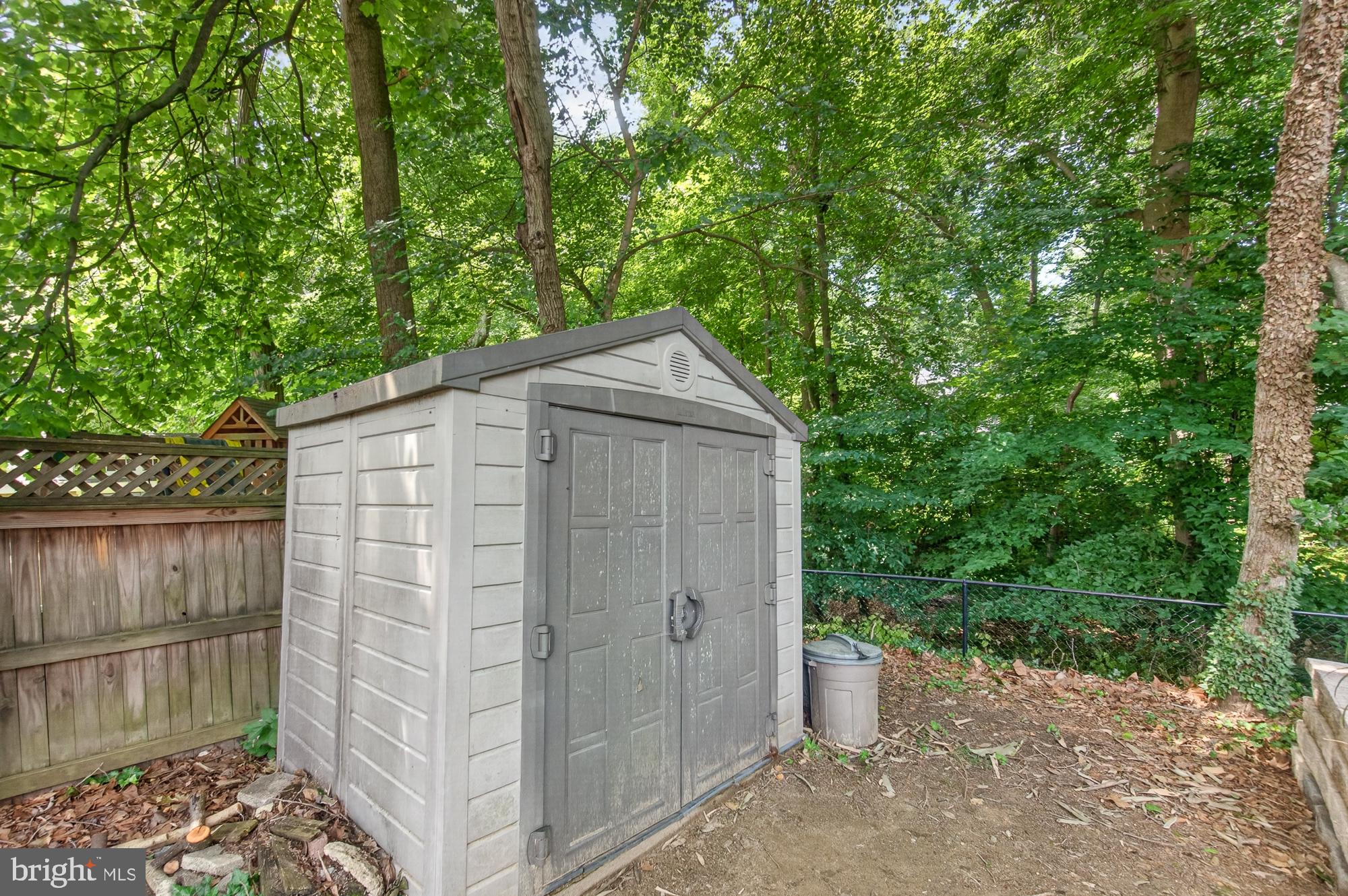 10202 Leslie Street Silver Spring, MD 20910 - Photo 38 of 44 Charming shed nestled in lush greenery.