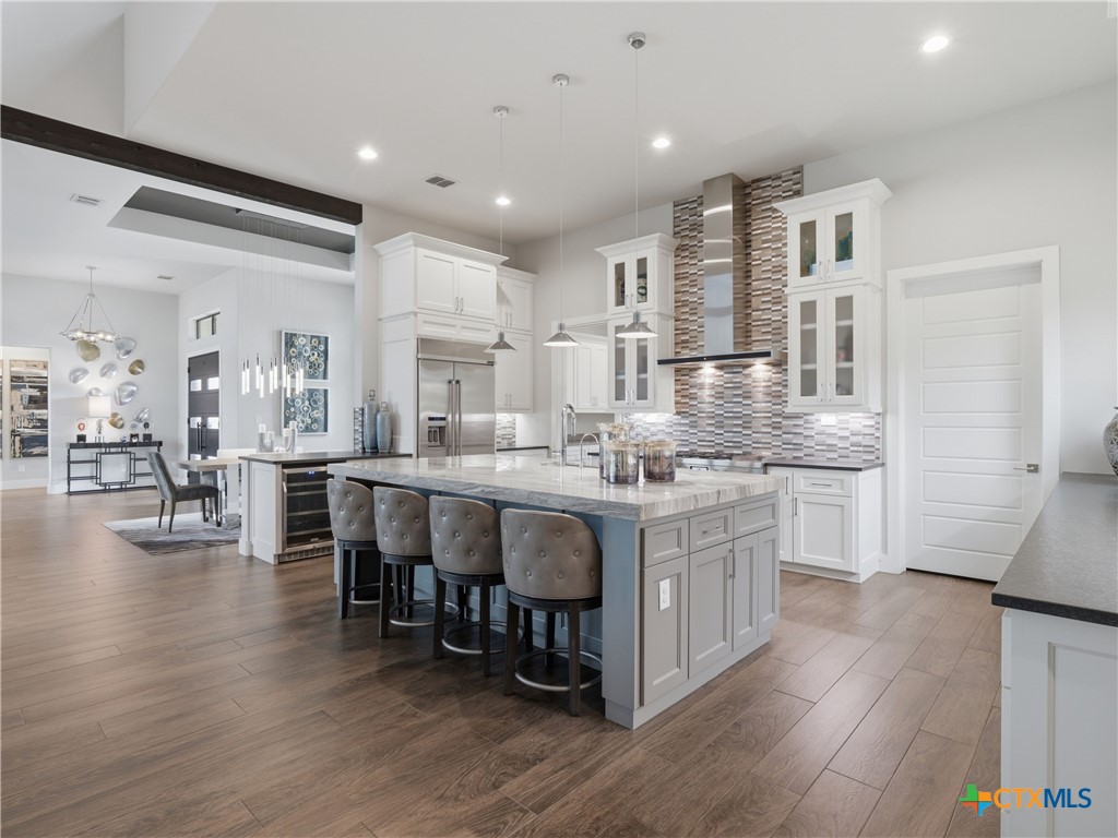 5913 Verden Ridge New Braunfels, TX 78132 - Photo 6 of 48 a large kitchen with lots of counter space and a dining table chairs