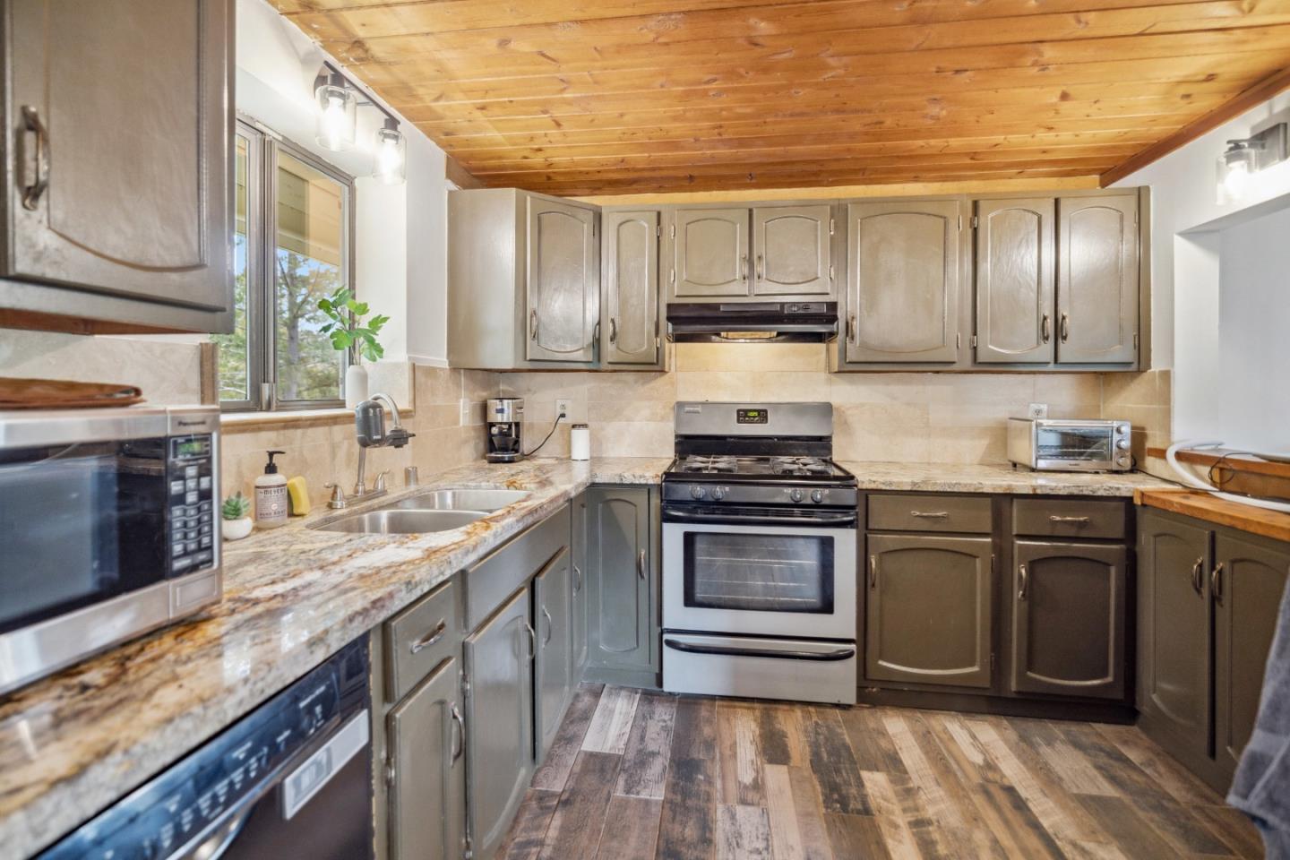 234 Dorrance Road Boulder Creek, CA 95006 - Photo 15 of 45 a kitchen with stainless steel appliances granite countertop a stove a sink dishwasher and a microwave oven with cabinets
