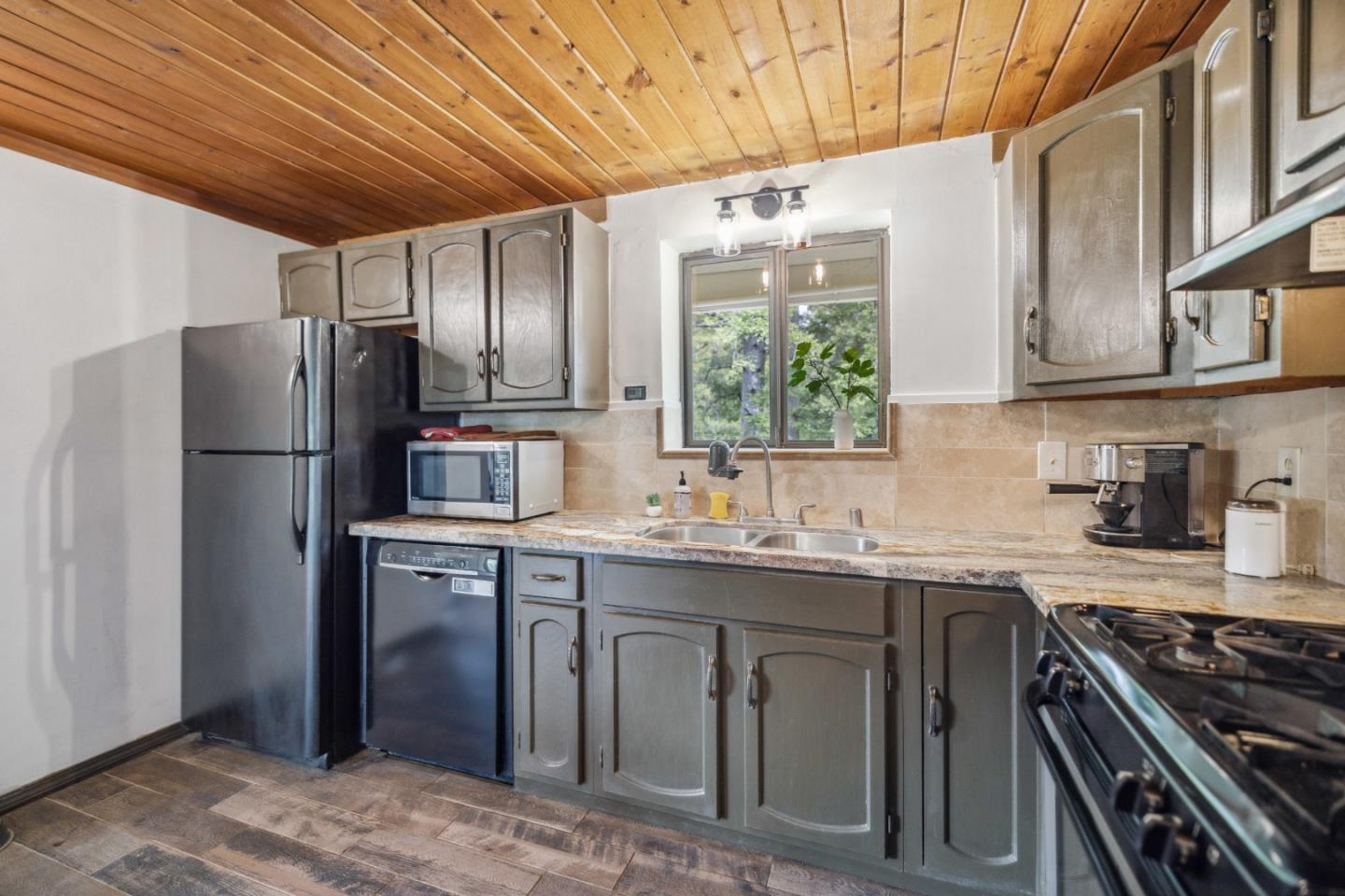 234 Dorrance Road Boulder Creek, CA 95006 - Photo 16 of 45 a kitchen with stainless steel appliances granite countertop a refrigerator a sink dishwasher a stove and white countertops with wooden floor