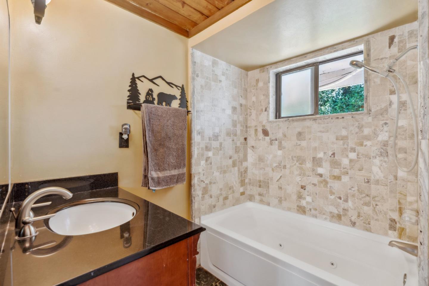234 Dorrance Road Boulder Creek, CA 95006 - Photo 9 of 45 a bathroom with a granite countertop sink and a bathtub