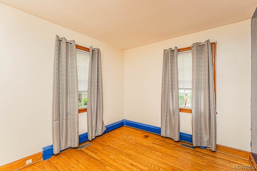 7418 Atlee Road Mechanicsville, VA 23111 - Photo 13 of 26 a bedroom with a bed and wooden floor