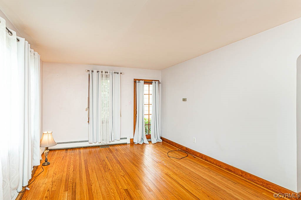 7418 Atlee Road Mechanicsville, VA 23111 - Photo 4 of 26 an empty room with wooden floor and windows