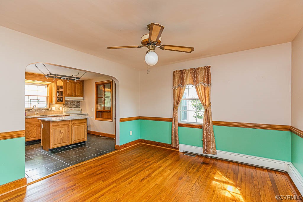 7418 Atlee Road Mechanicsville, VA 23111 - Photo 9 of 26 a view of an empty room with window wooden floor and a kitchen