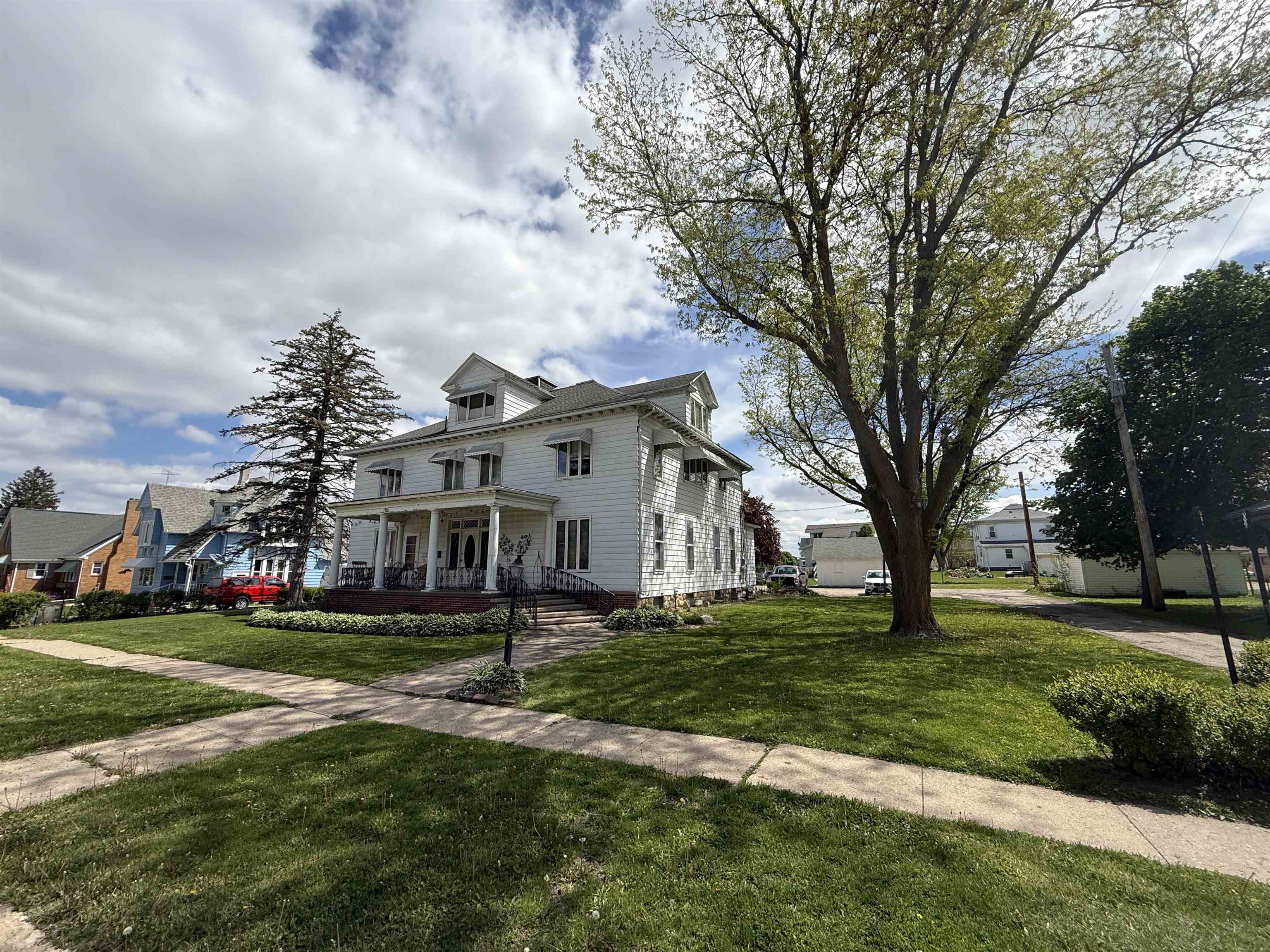 323 South Main Street Stockton, IL 61085 - Photo 31 of 32 a front view of a house with a garden and trees