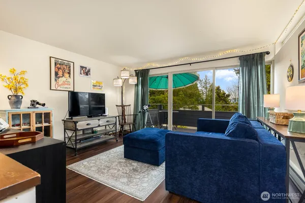 a living room with furniture large windows and a flat screen tv