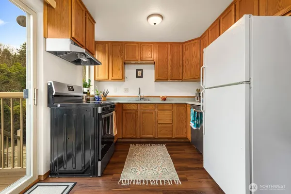 a kitchen with a sink a refrigerator and cabinets