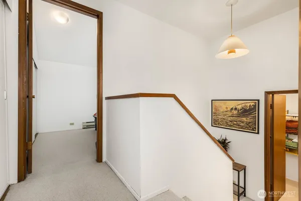 a view of a hallway with paintings on the wall