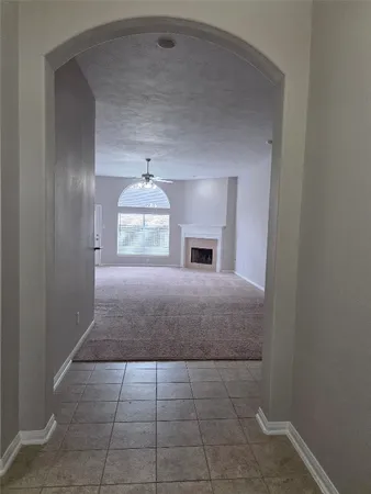 a view of empty room with a fireplace