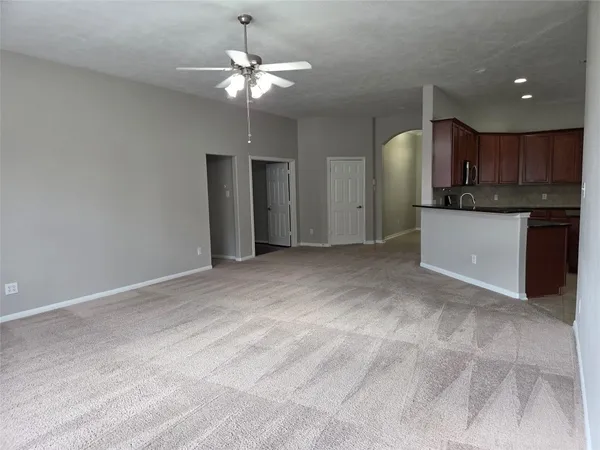 a view of a kitchen with a sink and chandelier