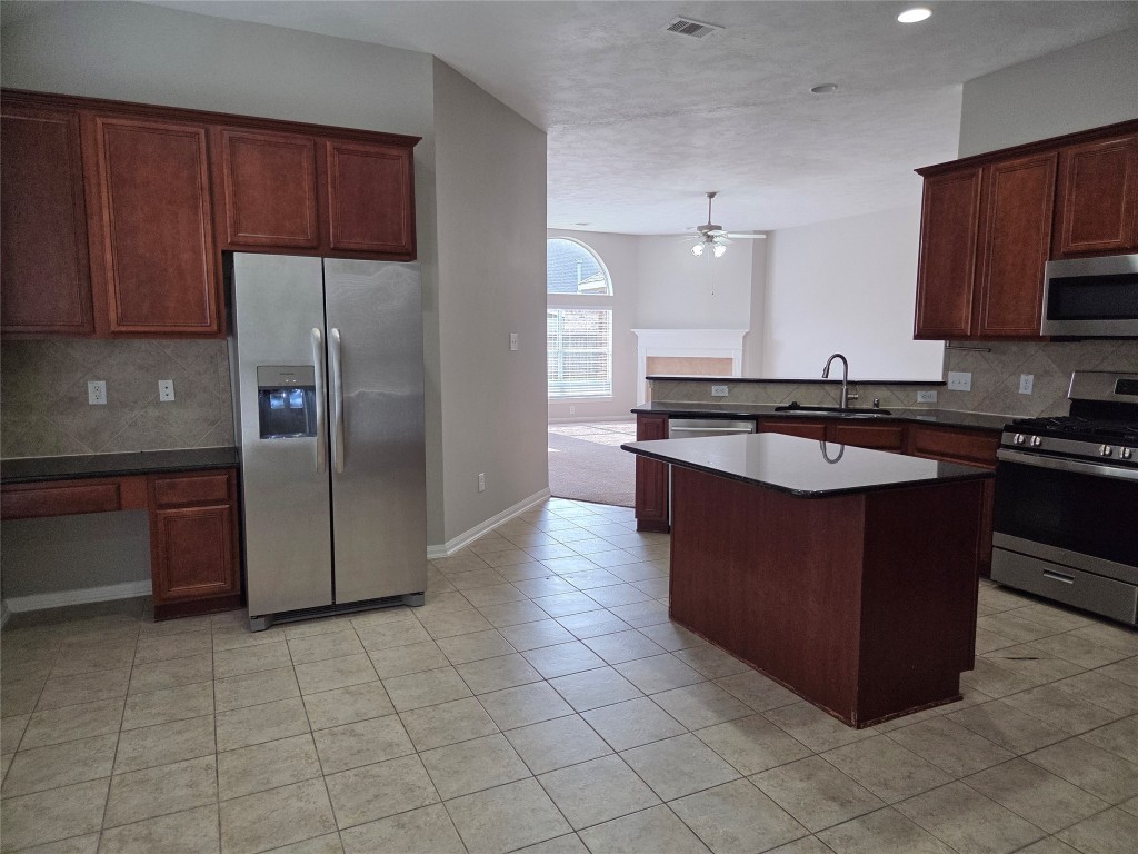 2203 Winchester Lake Rosenberg, TX 77471 - Photo 7 of 20 a kitchen with stainless steel appliances granite countertop a stove a refrigerator and a sink