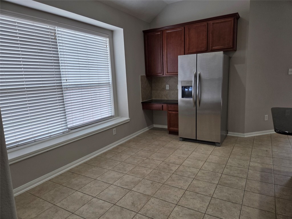2203 Winchester Lake Rosenberg, TX 77471 - Photo 9 of 20 a kitchen with stainless steel appliances a refrigerator and a window