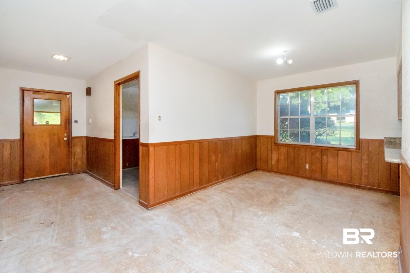 241 Suzanne Circle Mobile, AL 36608 - Photo 6 of 41 Empty room featuring wainscoting and wood walls
