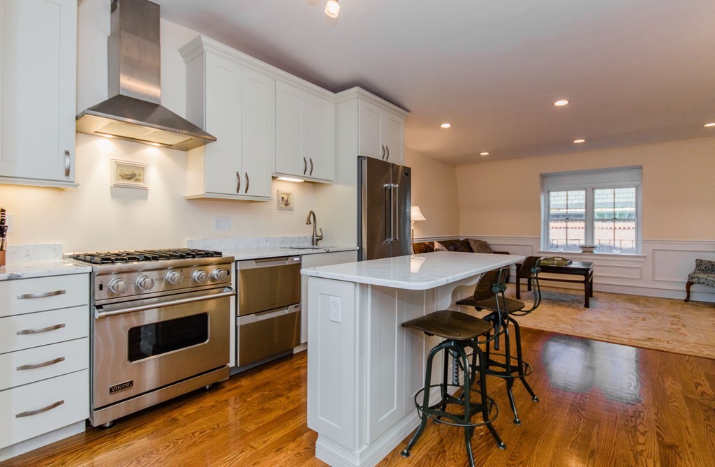 a kitchen with a stove a sink and a refrigerator