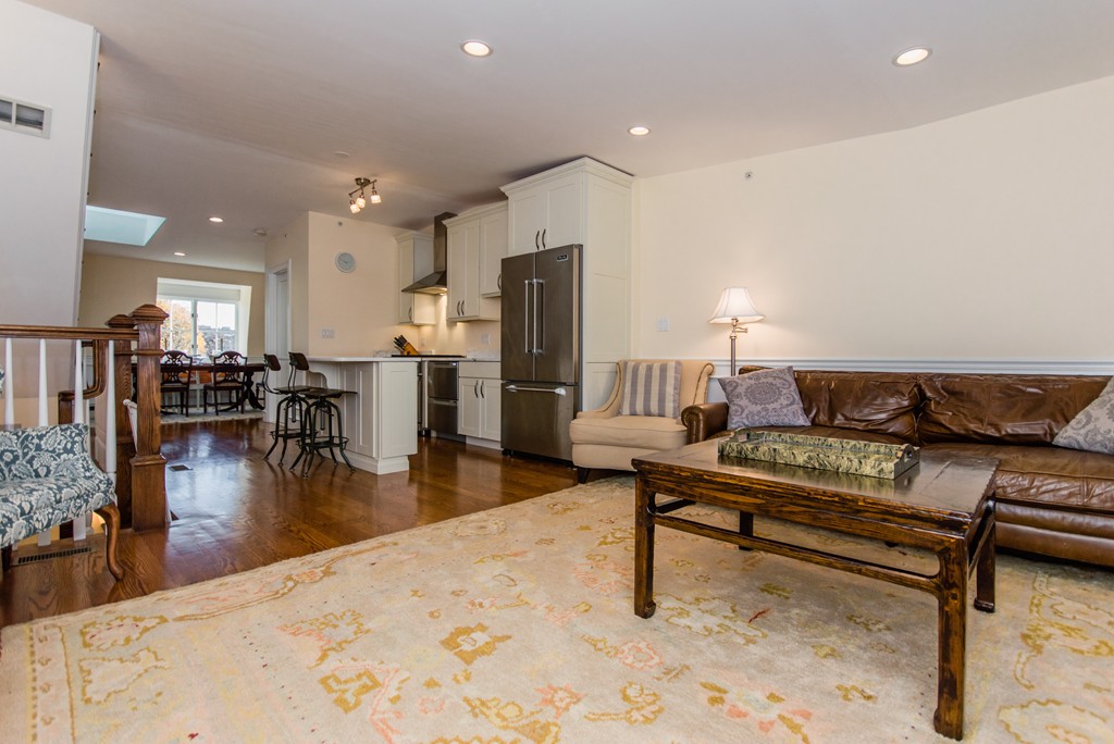 123 Warren Avenue, Unit 2 Boston, MA 02116 - Photo 4 of 13 a living room with furniture and a dining table with wooden floor