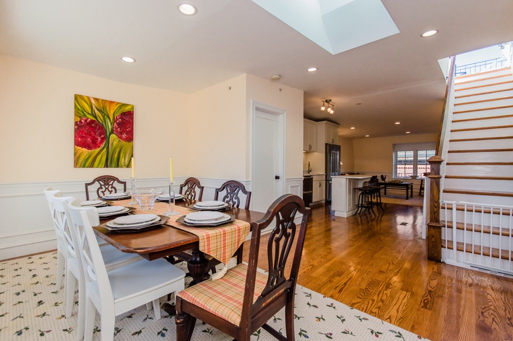 123 Warren Avenue, Unit 2 Boston, MA 02116 - Photo 5 of 13 a dining room with furniture and a wooden floor