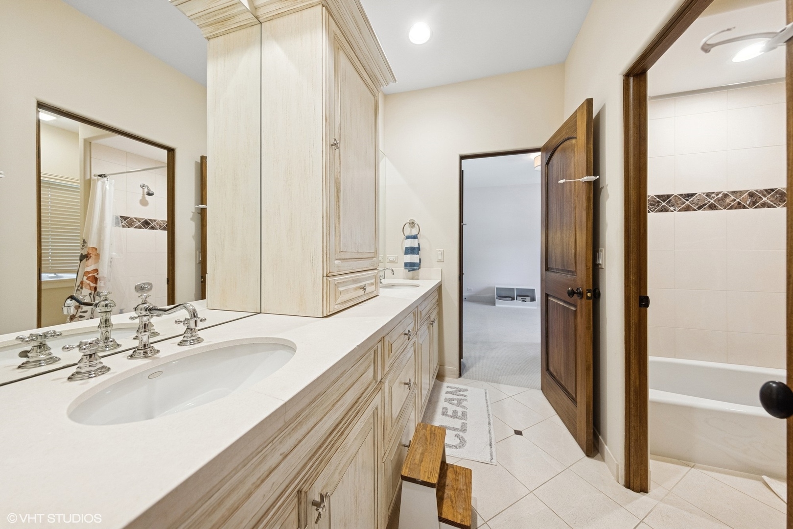 437 North County Line Road Hinsdale, IL 60521 - Photo 18 of 25 a bathroom with a double vanity sink a mirror and a shower