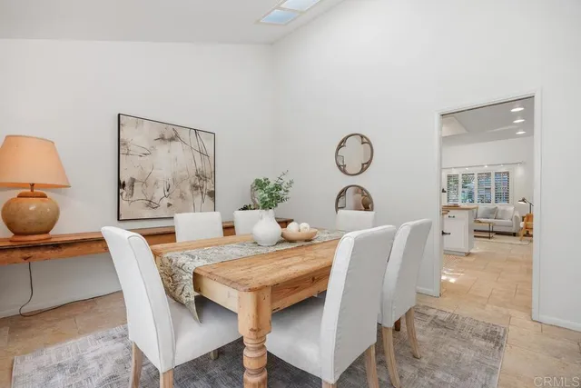 a view of a dining room with furniture and a rug