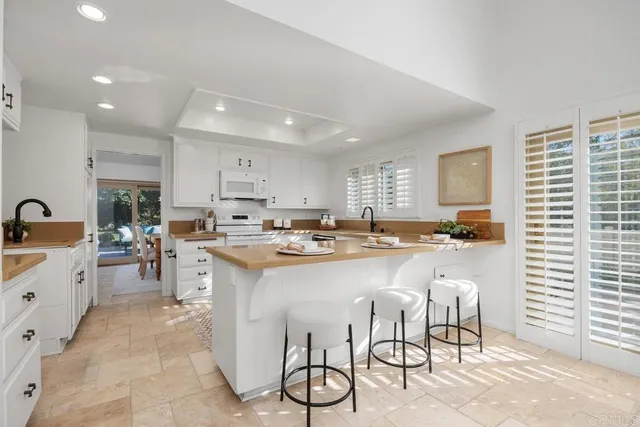 a kitchen with counter top space a sink cabinets and appliances