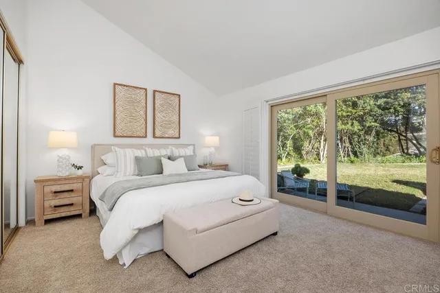 a bedroom with a bed and a large window
