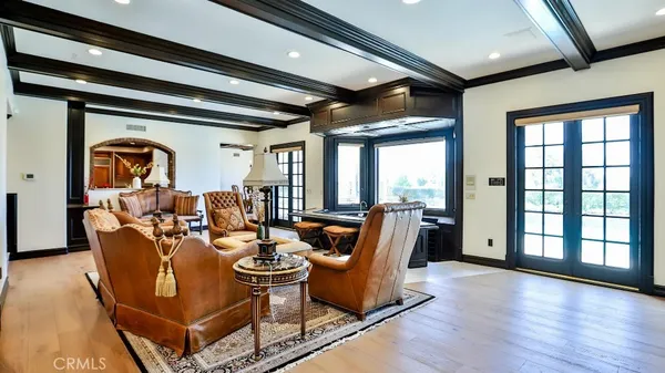 a living room with fireplace furniture and a large window