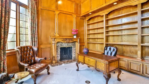 a living room with furniture cabinets and a window