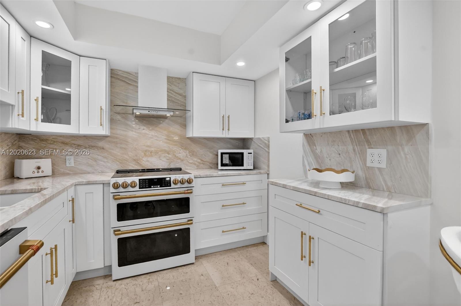 4101 North Ocean Boulevard, Unit 1605 Boca Raton, FL 33431 - Photo 5 of 35 a kitchen with cabinets appliances and a window