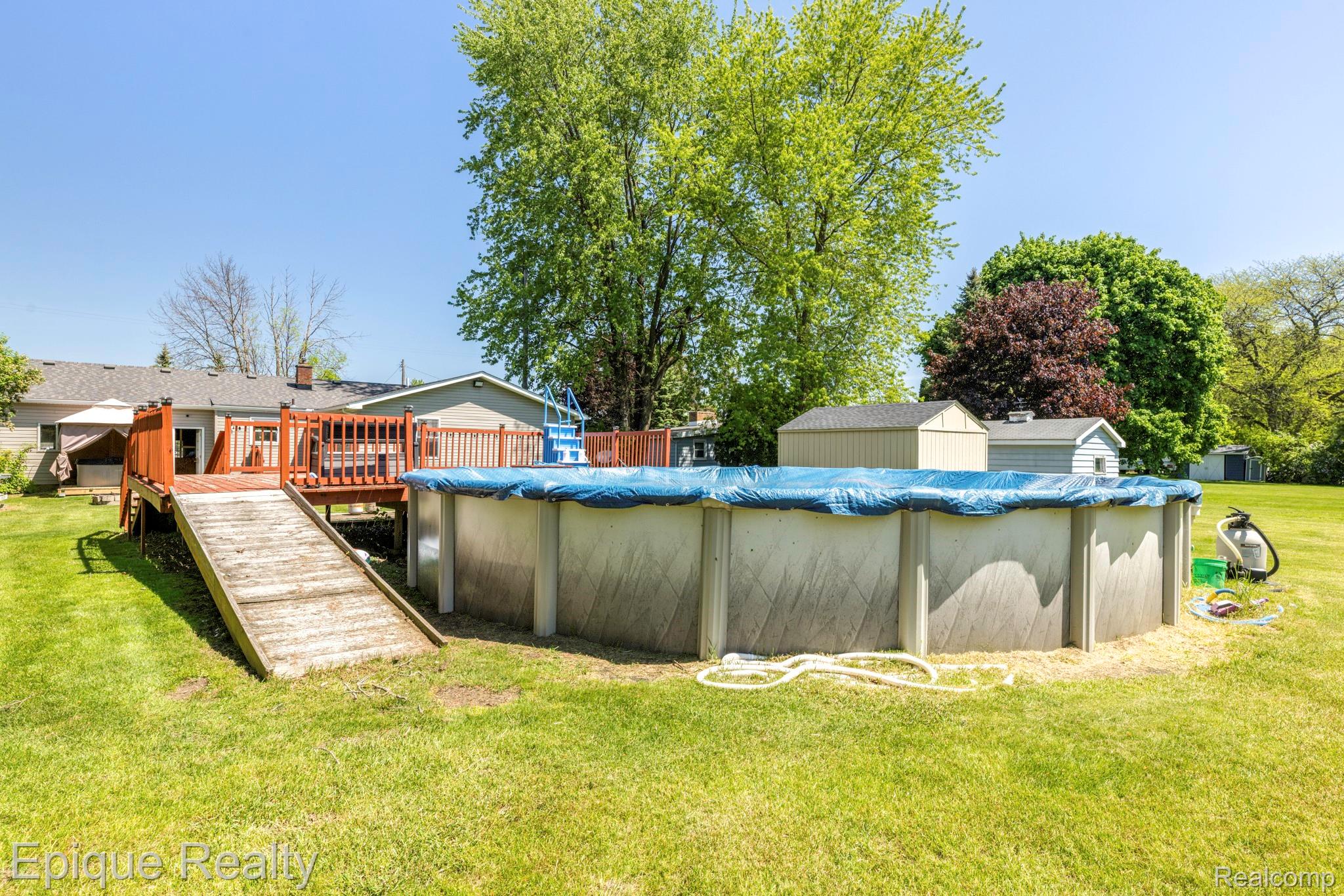 11110 Davison Road Davison, MI 48423 - Photo 56 of 65 View of swimming pool featuring a deck, a covered pool, and a yard