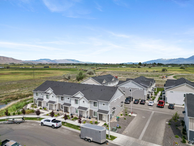 1223 East 1775 North Payson, UT 84651 - Photo 15 of 45 Contemporary townhome development featuring light gray siding with white trim, dark shingled roofs, and individual front entrances
