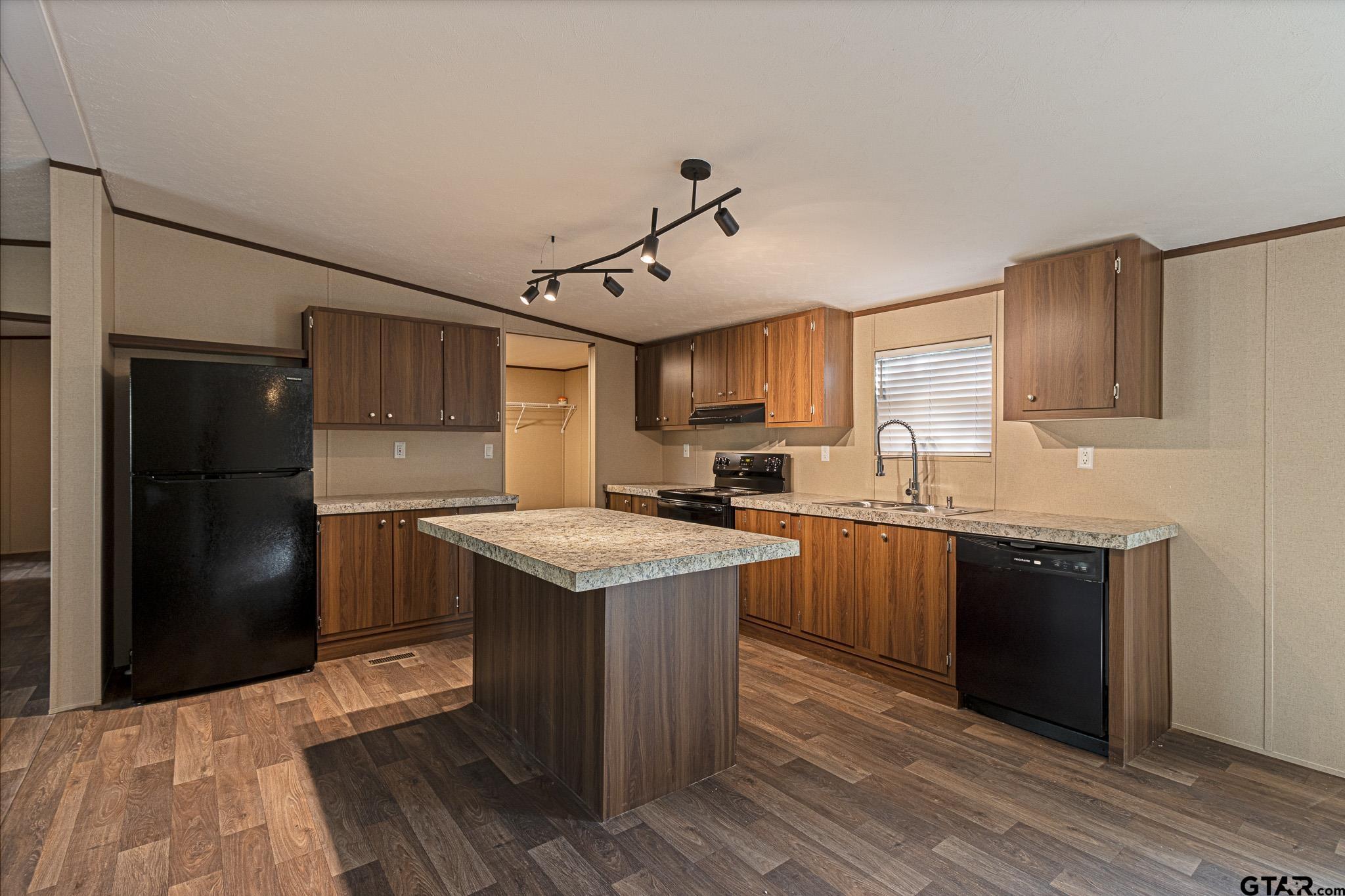 9806 FM 773 Murchison, TX 75778 - Photo 12 of 35 a kitchen with a sink refrigerator and cabinets