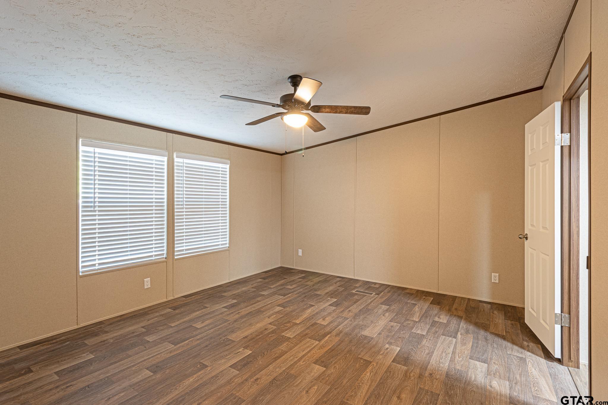 9806 FM 773 Murchison, TX 75778 - Photo 15 of 35 a view of empty room with wooden floor and fan