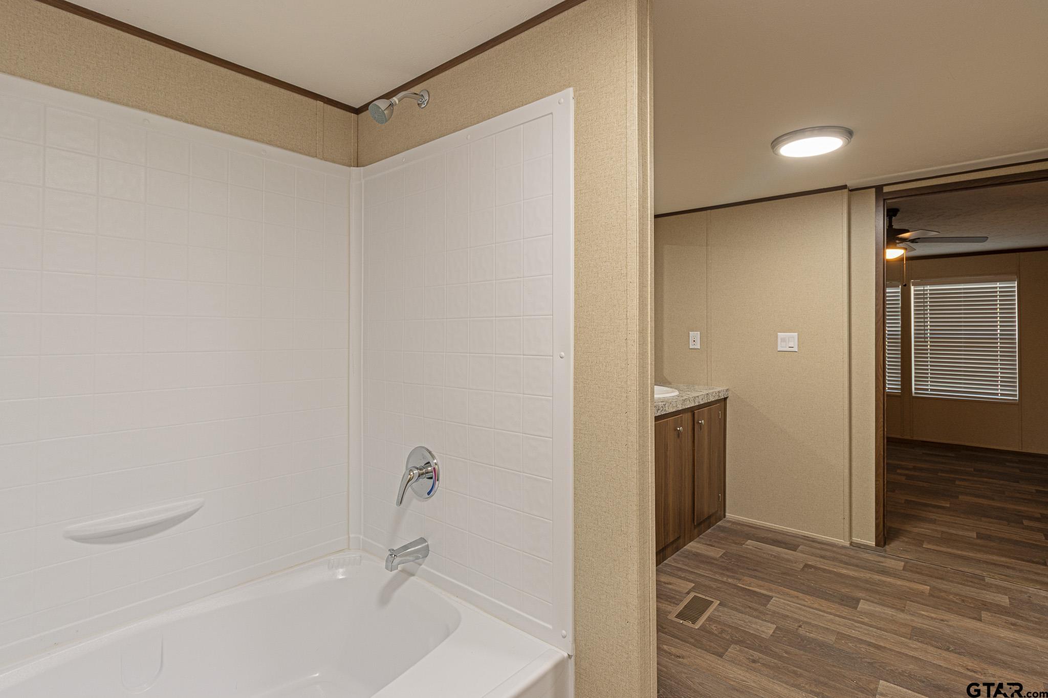 9806 FM 773 Murchison, TX 75778 - Photo 18 of 35 a bathroom with a bathtub and a shower