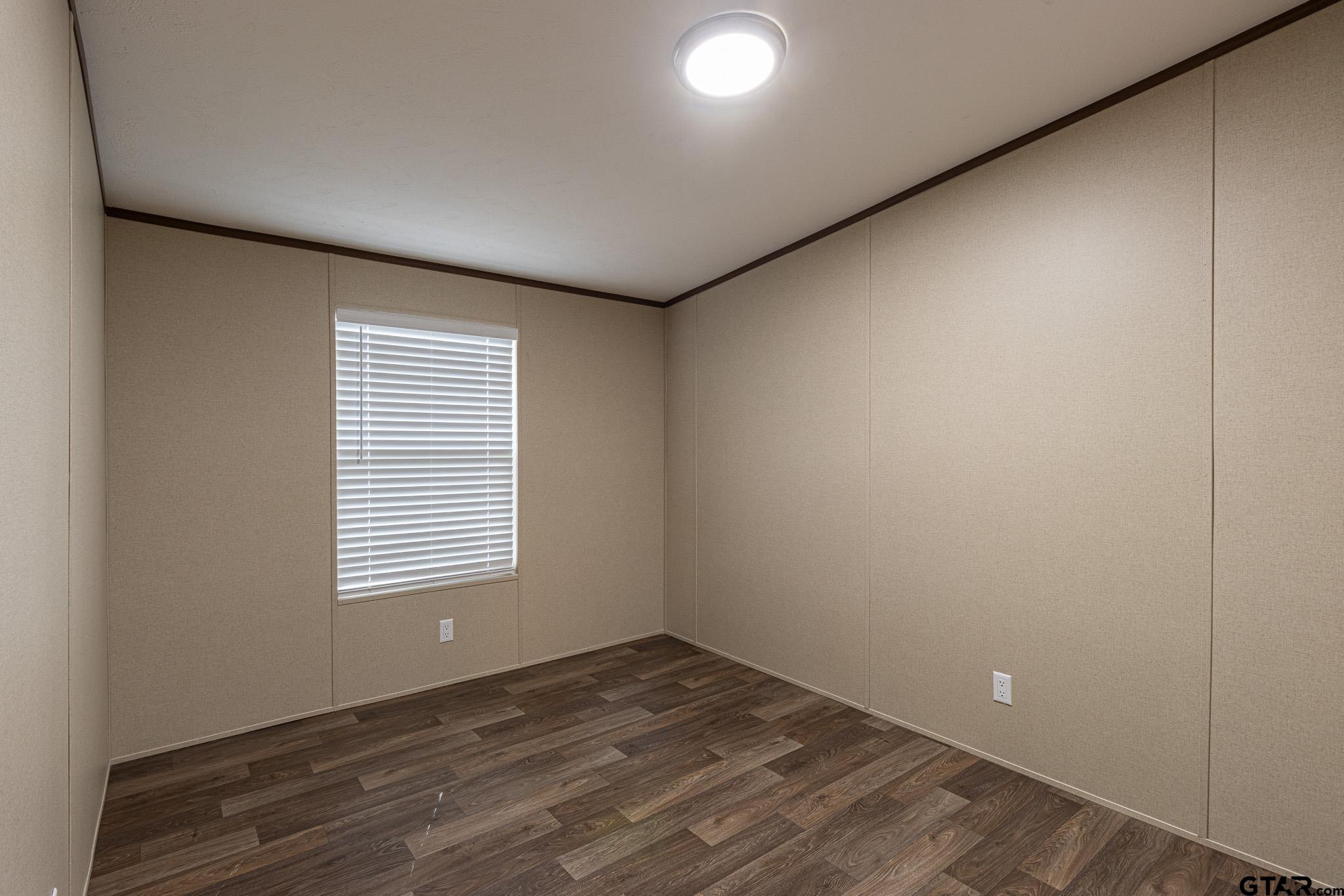 9806 FM 773 Murchison, TX 75778 - Photo 21 of 35 a view of an empty room with wooden floor and a window