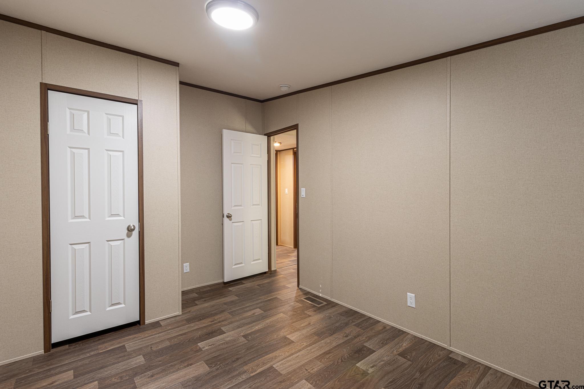 9806 FM 773 Murchison, TX 75778 - Photo 23 of 35 an empty room with wooden floor and closet area