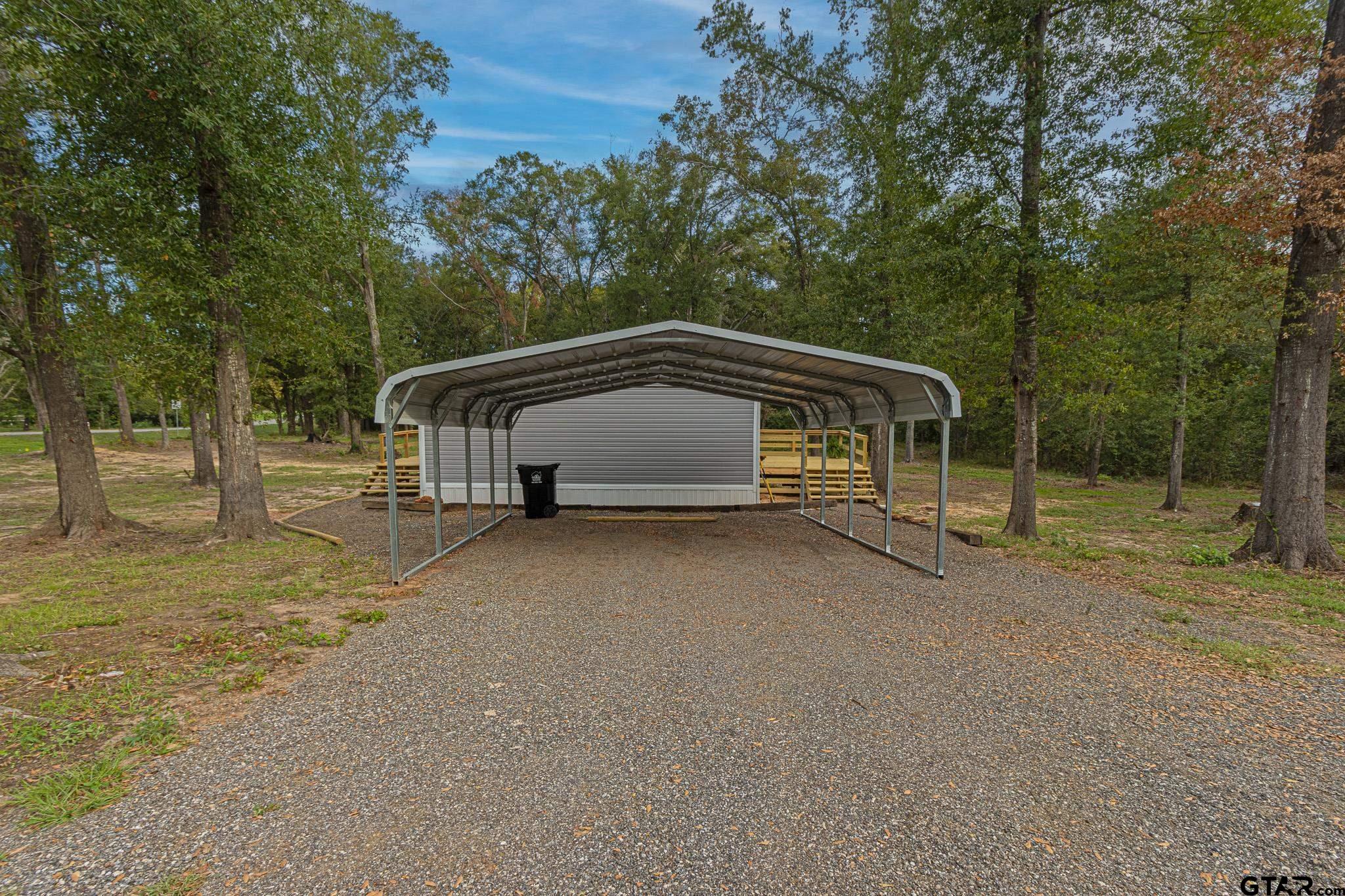 9806 FM 773 Murchison, TX 75778 - Photo 29 of 35 a house with trees in the background