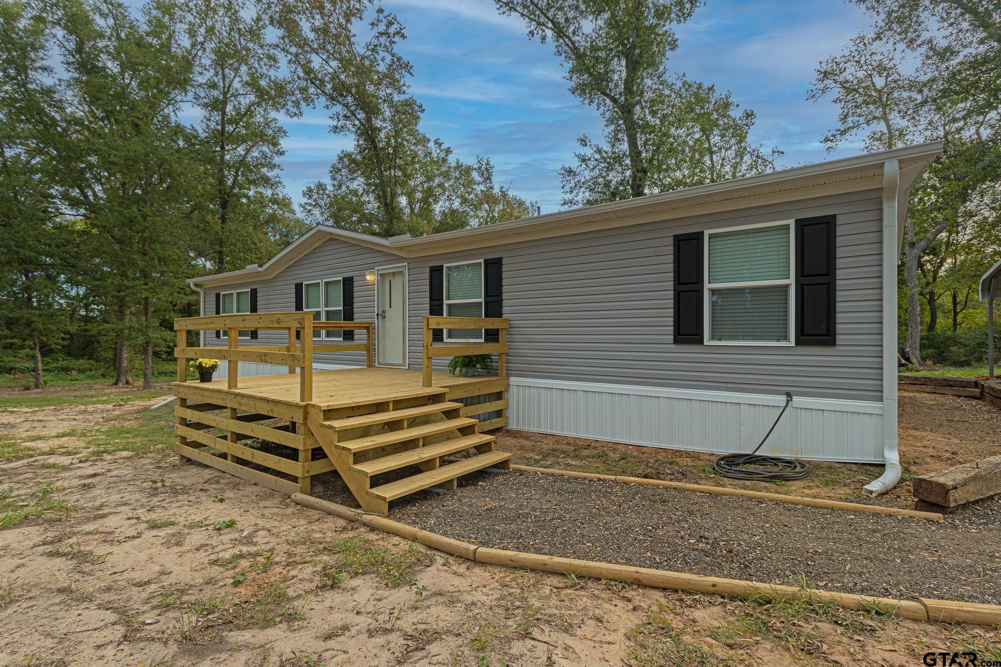 9806 FM 773 Murchison, TX 75778 - Photo 4 of 35 a front view of a house with a yard