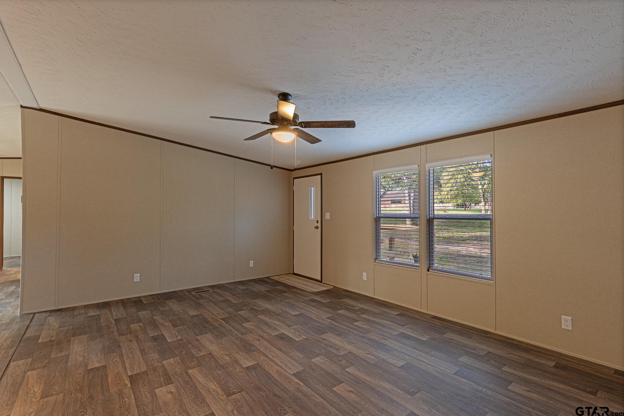9806 FM 773 Murchison, TX 75778 - Photo 5 of 35 a view of an empty room with a window and wooden floor