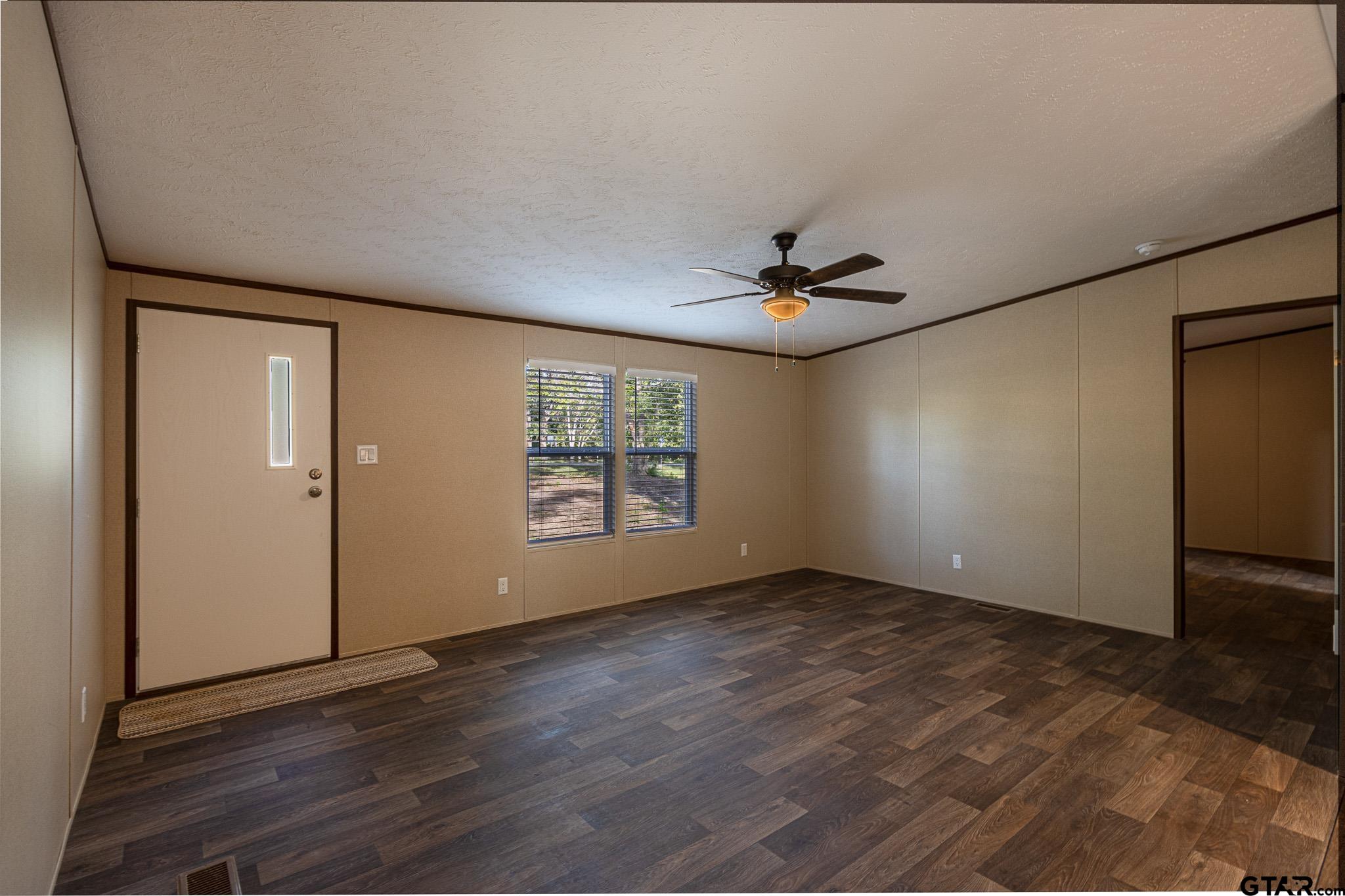 9806 FM 773 Murchison, TX 75778 - Photo 6 of 35 an empty room with wooden floor and windows