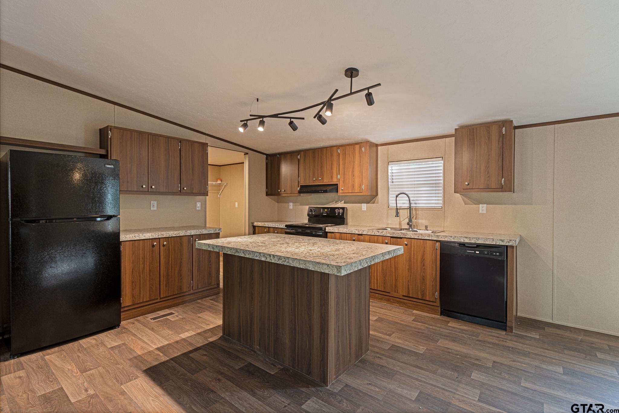 9806 FM 773 Murchison, TX 75778 - Photo 9 of 35 a kitchen with a sink a refrigerator and a stove