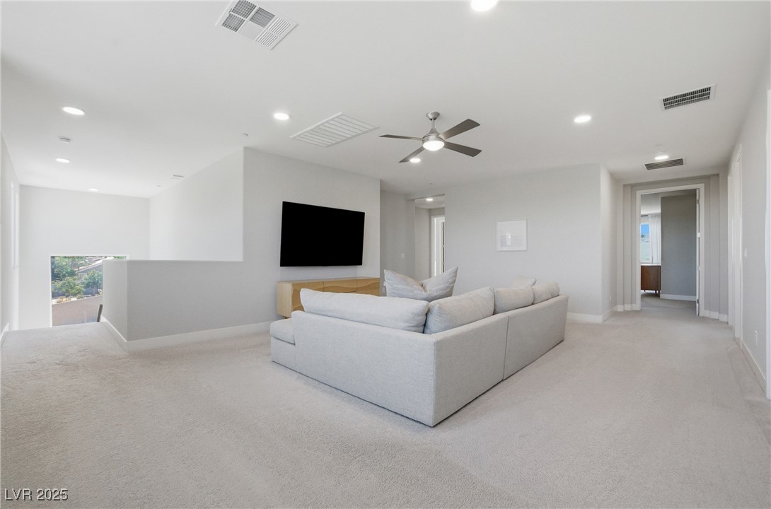 7736 Tioga Ridge Las Vegas, NV 89117 - Photo 18 of 68 Carpeted living room featuring recessed lighting and ceiling fan