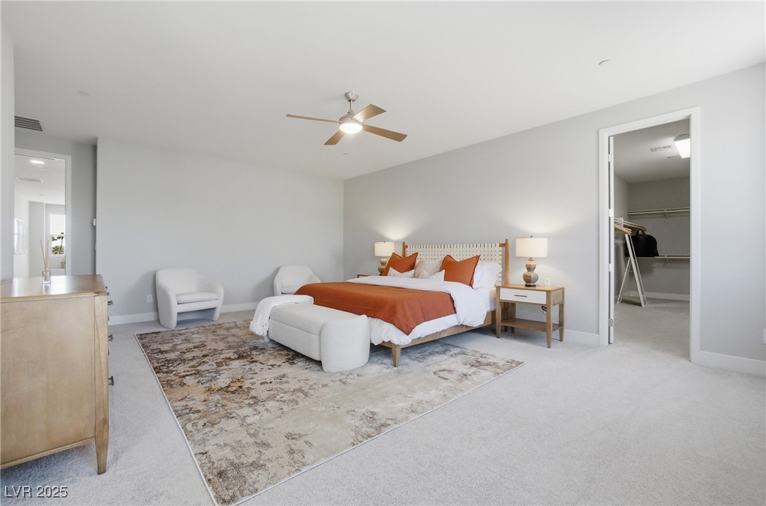 7736 Tioga Ridge Las Vegas, NV 89117 - Photo 23 of 68 Bedroom with a spacious closet, light carpet, and a ceiling fan