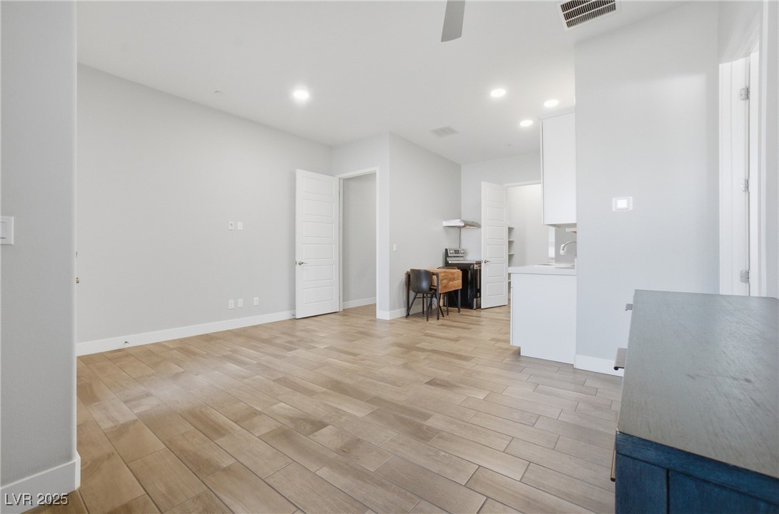7736 Tioga Ridge Las Vegas, NV 89117 - Photo 47 of 68 Unfurnished living room featuring light wood-style flooring, recessed lighting, and ceiling fan