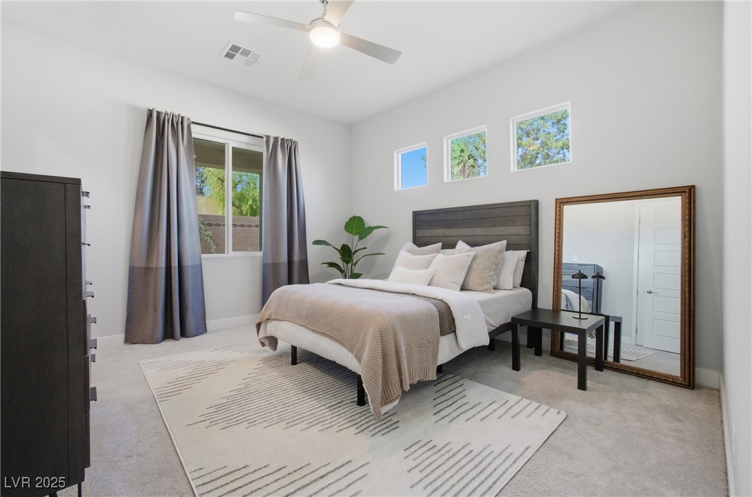 7736 Tioga Ridge Las Vegas, NV 89117 - Photo 49 of 68 Bedroom with light carpet and ceiling fan