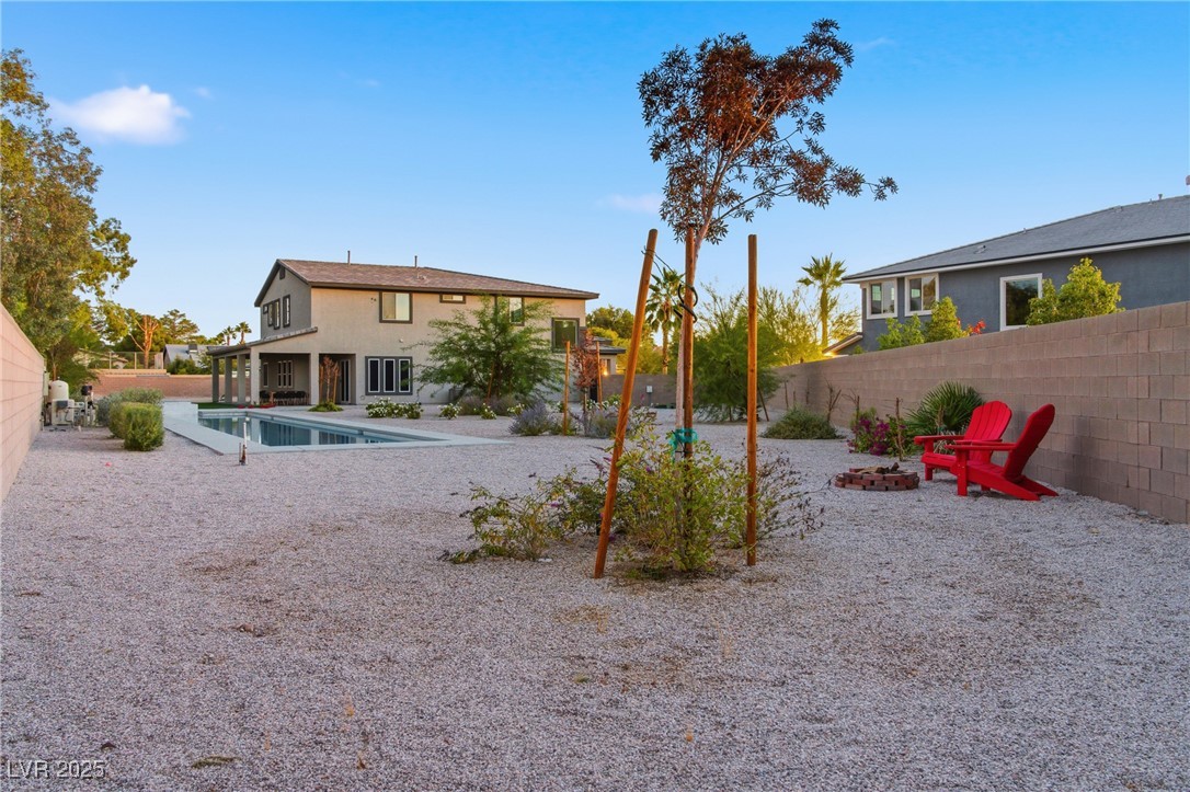 7736 Tioga Ridge Las Vegas, NV 89117 - Photo 57 of 68 Back of house with a fenced backyard, a patio, and an outdoor fire pit