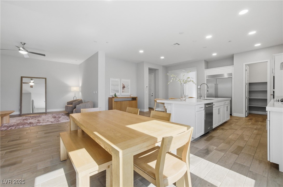 7736 Tioga Ridge Las Vegas, NV 89117 - Photo 6 of 68 Dining area featuring light wood-style flooring, recessed lighting, and a ceiling fan